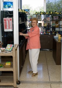 photo of old woman standing in gift shop